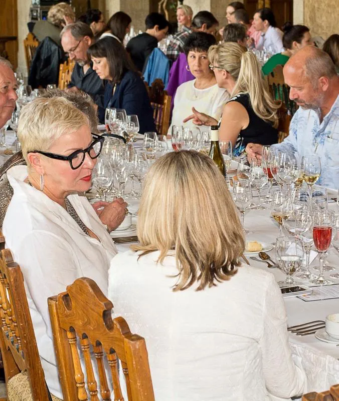 Guests at a long-table dinner service